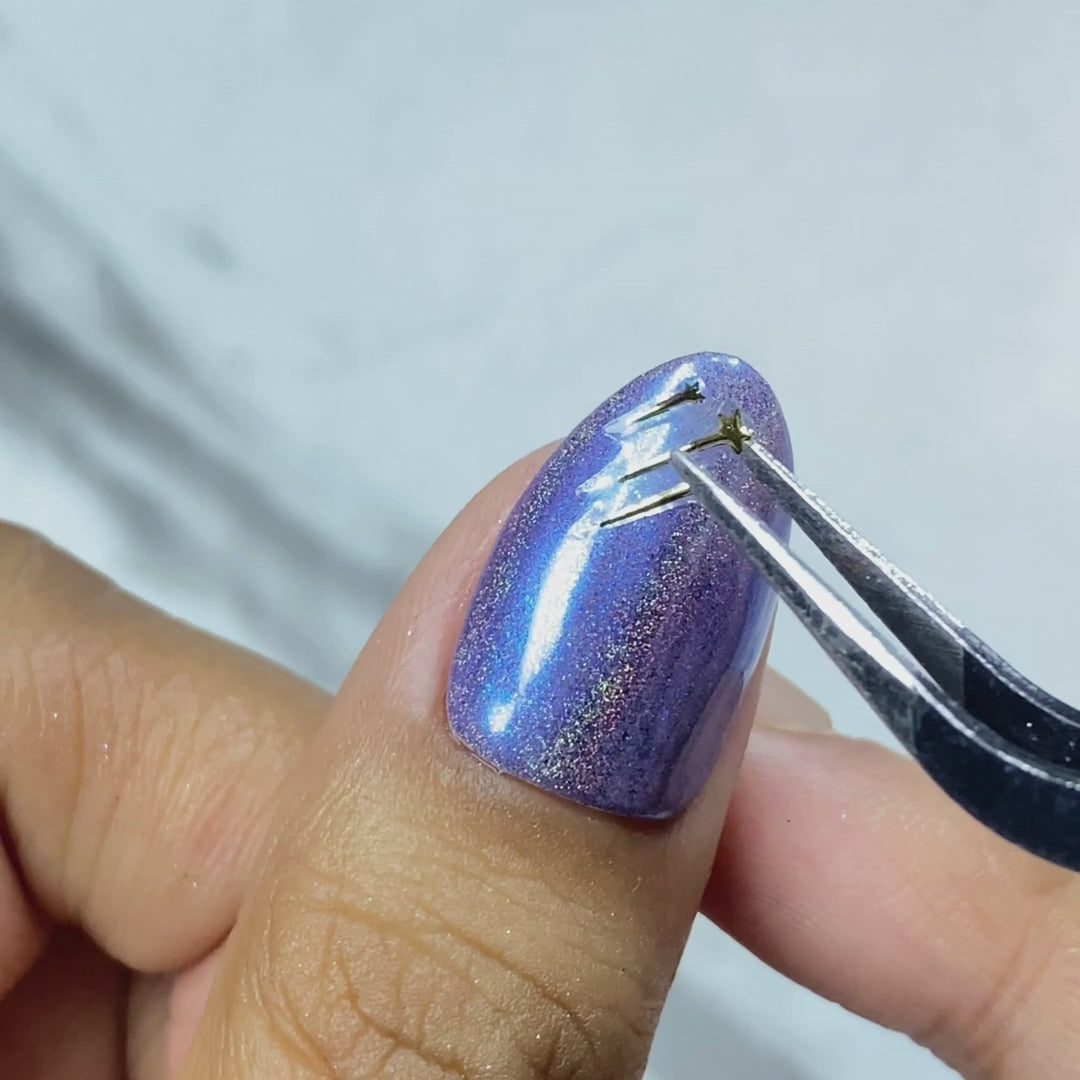 Applying Galactica nail embellishments